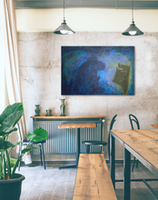 Load image into Gallery viewer, Painting of 2 friendly monsters chatting, hanging on stucco wall with a rustic wood table in front, industrial lights above and big palm plant
