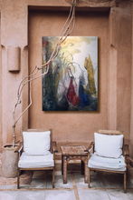 Load image into Gallery viewer, Painting of three women hanging on a stucco wall above two chairs and a colorful tile table
